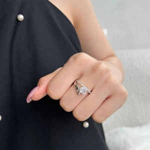 Close-up of S925 silver ring featuring a split band with pavé crystals and a large round stone