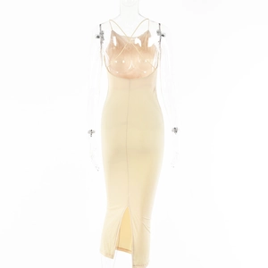 Detail view of beige bodycon dress featuring back criss-cross straps and rear slit design
