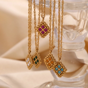 Close-up of a 18K gold-plated rhombus pendant with colorful crystals on a twisted chain