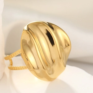 Macro view of gold stainless steel ring with folded texture and double-row band design