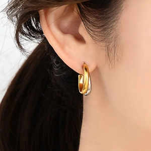 Minimalist interlocking C-shape hoop earrings in two-tone gold and silver finish