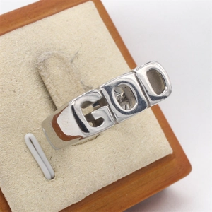 Vintage silver GOD hip-hop ring for men made of stainless steel on wooden display