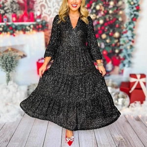 Detail of tiered black sequin dress with a deep V-neck and elegant layered skirt design