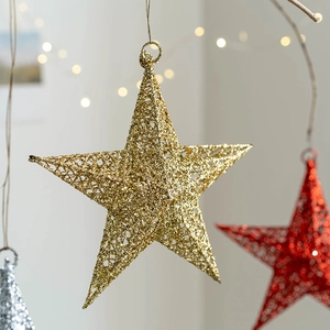 Golden iron Christmas star decoration with hollow mesh and glitter for festive window display