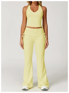 Detail of light yellow yoga vest with V-neck design and high-waist flared leggings