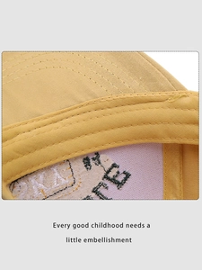 Detail shot of the embroidery and reinforced stitching inside the yellow cotton baseball cap