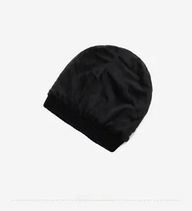 Detail view of the soft fleece lining inside a black knitted beanie for winter warmth