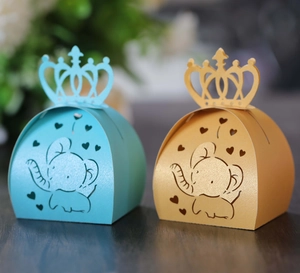 Detailed view of blue and gold hollow elephant gift boxes with crown and heart cutouts