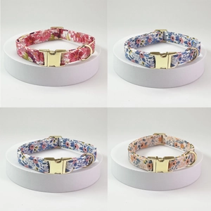 Detailed view of floral cotton pet collars with gold metal buckles in four colors