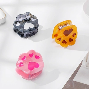 Three cute acetate cat claw hair clips with hollow heart patterns in assorted colors