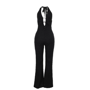 Detailed back view of a black halter jumpsuit with crisscross lace-up straps and open back