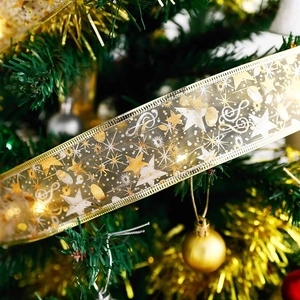 Detail of gold mesh ribbon with warm LED lights and star patterns for Christmas tree décor