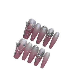Handmade pink cat-eye press-on nails with luxury metal butterflies and silver glitter
