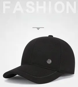Detail of warm black cotton baseball cap with ear protection and metal logo decoration