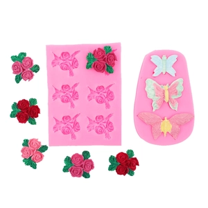 Detail of pink silicone molds for rose clusters and butterflies with resin models