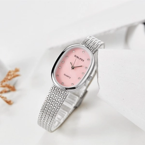 Detailed view of an oval pink dial with mesh strap and crystal hour markers
