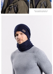 Detail of navy blue winter knitted hat and scarf set with fleece lining and leather patch