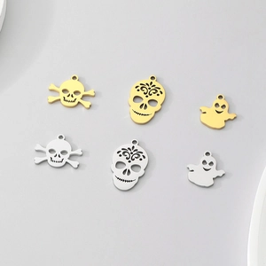 Macro view of Halloween skull and ghost charms in gold and silver finishes