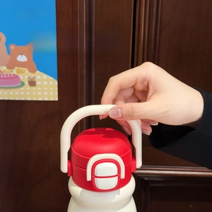 Detail showing red and white insulated water bottle with portable U-shaped carry handle