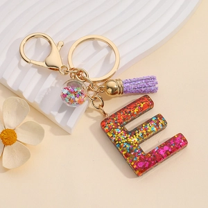 Red gradient glitter resin letter E keychain with purple tassel and star charm