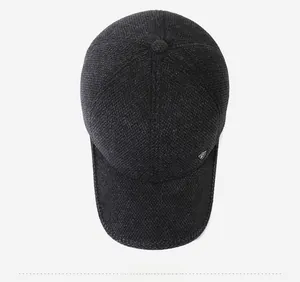 Top down view of thick wool blend winter baseball cap with ear flaps and metal logo