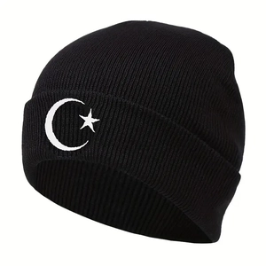 Classic black beanie featuring white moon and star embroidery in a warm knitted style