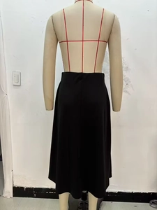 Rear view of an elegant black A-line midi skirt with a clean knot design on a mannequin