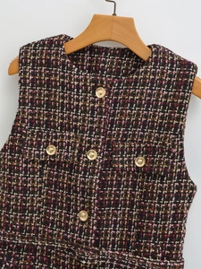 Detail of multi-color tweed vest texture with five decorative golden metal buttons
