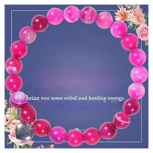 Detail of pink agate bead bracelet with heart pendant on a gift card background