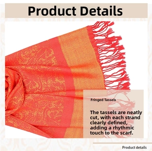 Detailed close-up of handmade tassels on a luxury jacquard scarf with paisley patterns
