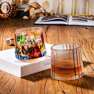 Artistic thick colored whiskey glass set with rotating wooden base and textured glass patterns
