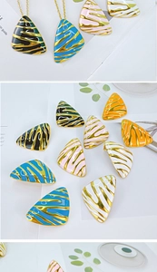 Detail showing colorful triangular enamel jewelry with gold zebra patterns and necklaces
