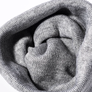 Thick grey knitted beanie hat with detailed jacquard texture and warm thermal fabric