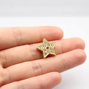 Detailed view of a gold-plated star charm with sparkling crystals for DIY jewelry making
