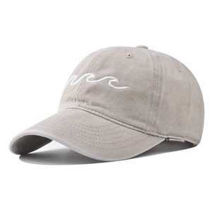 Detail shot of khaki washed cotton baseball cap with white wave embroidery