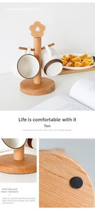 Detail of beech wood mug tree stand with anti-slip base and hanging ceramic cups
