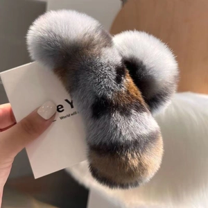 Close-up of oversized plush faux fur hair claw in grey and brown gradient mix