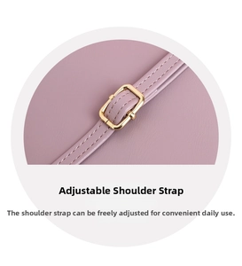 Detail of adjustable leather shoulder strap with a polished light gold metal pin buckle