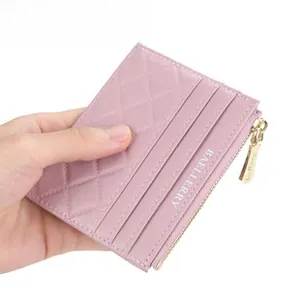 Close-up of pink quilted card holder with multi-slots and metal zipper detail