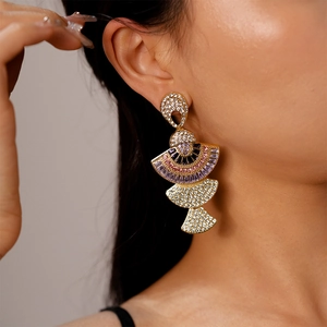 Detail view of large multi-layer fan-shaped earrings with colorful zirconia stones