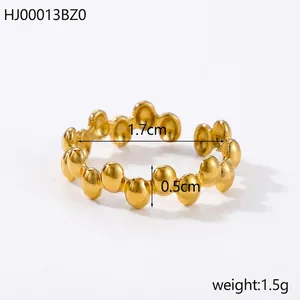 Detailed macro view of 18K gold open ring featuring a unique 3D dotted textured pattern