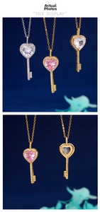 Detailed views of heart key necklaces with zirconia in silver, gold, and pink finishes