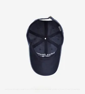 Interior view of navy blue washed cotton baseball cap with adjustable metal buckle and labels