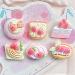 Detail of pink strawberry cake resin flatbacks for DIY hair clips and phone cases