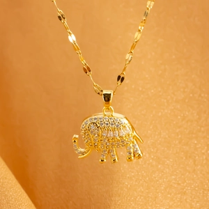 Golden elephant pendant necklace featuring sparkling white cubic zirconia on flat link chain
