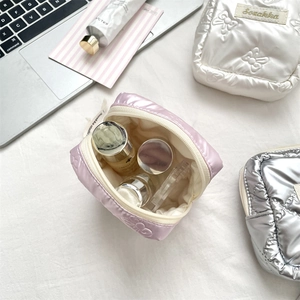 Close-up of quilted heart mini storage pouch showing soft texture and compact interior space