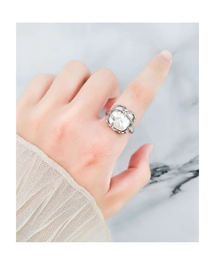 Close-up of S925 silver vine ring with pearl on model's finger with marble background