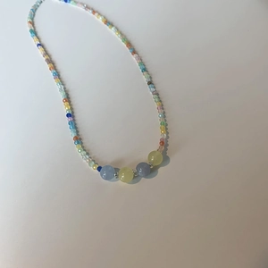 Macro shot of colorful beads and cat eye stones on a summer choker necklace