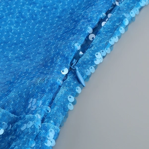 Detail of blue sequined dress showing high-quality invisible zipper and net fabric