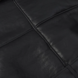 Detail of premium black leather material featuring precise diamond stitching and fine texture
